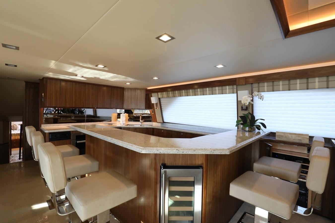 a large kitchen with a large island aboard 2022 VIKING 92 ENCLOSED SKYBRIDGE (TBD) Yacht for Sale