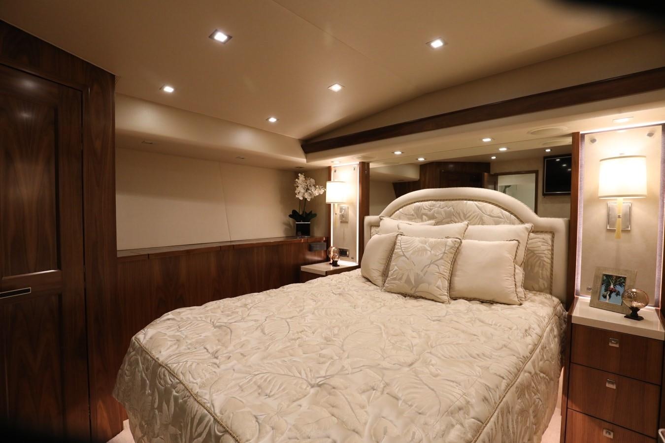 a bed with a white comforter aboard 2022 VIKING 92 ENCLOSED SKYBRIDGE (TBD) Yacht for Sale