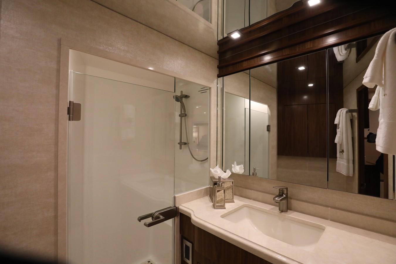 a bathroom with a shower and sink aboard 2022 VIKING 92 ENCLOSED SKYBRIDGE (TBD) Yacht for Sale