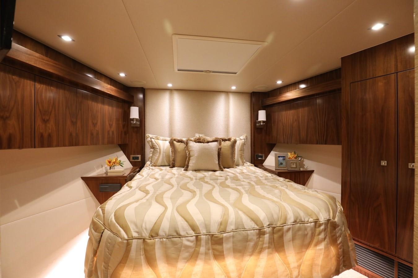 a bed in a room aboard 2022 VIKING 92 ENCLOSED SKYBRIDGE (TBD) Yacht for Sale