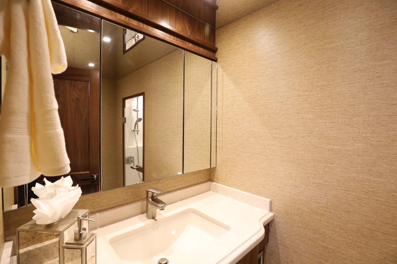 a bathroom with a large mirror aboard 2022 VIKING 92 ENCLOSED SKYBRIDGE (TBD) Yacht for Sale