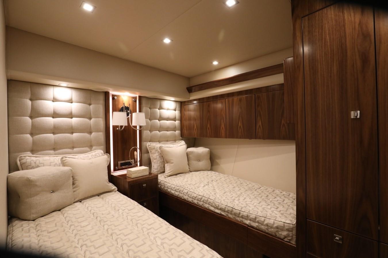 a room with a bed and a mirror aboard 2022 VIKING 92 ENCLOSED SKYBRIDGE (TBD) Yacht for Sale