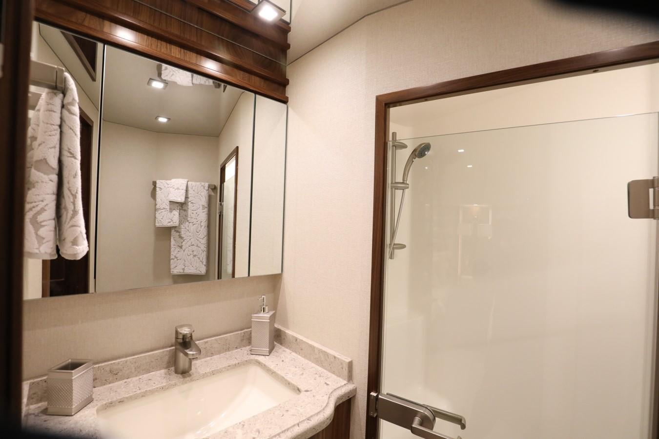 a bathroom with a large mirror aboard 2022 VIKING 92 ENCLOSED SKYBRIDGE (TBD) Yacht for Sale