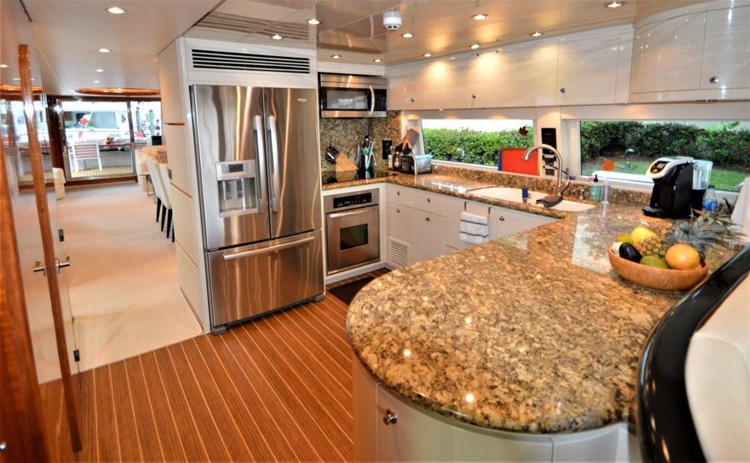 a kitchen with a stainless steel refrigerator aboard TRIPLE NET Yacht for Sale