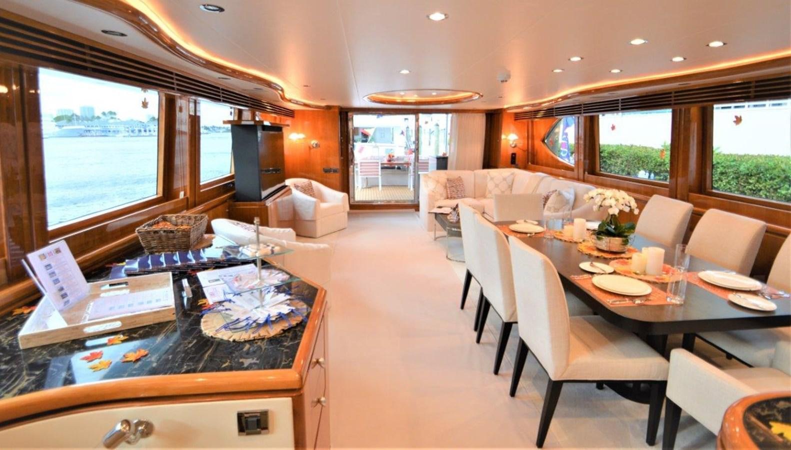 a large room with tables and chairs aboard TRIPLE NET Yacht for Sale