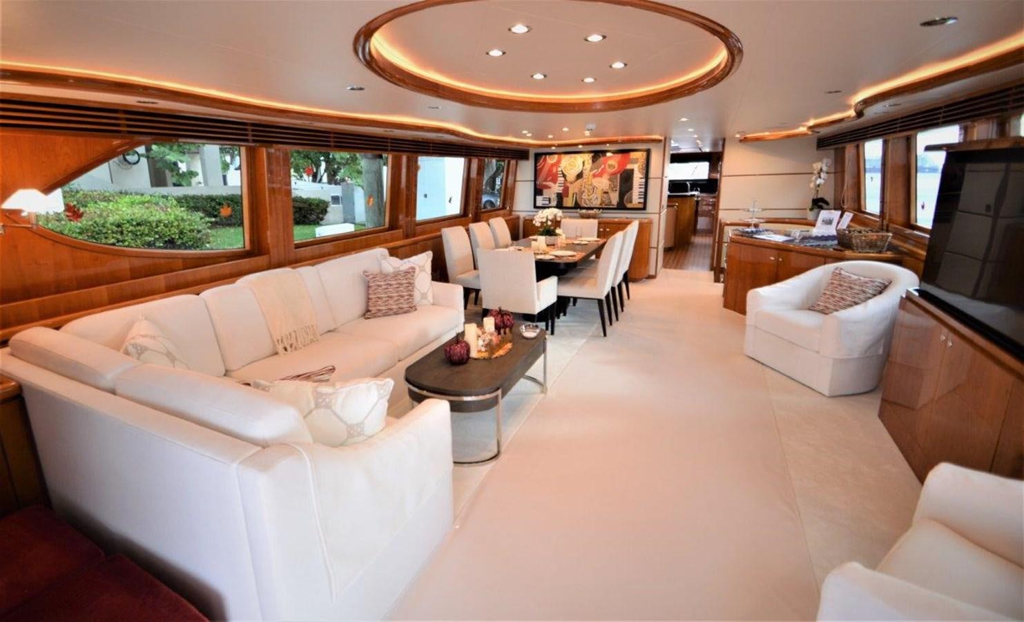 a living room with a couch and a table aboard TRIPLE NET Yacht for Sale