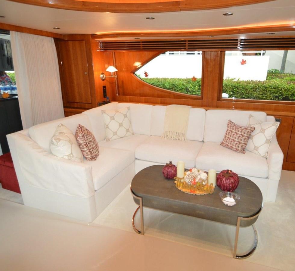 a living room with a couch and a table aboard TRIPLE NET Yacht for Sale