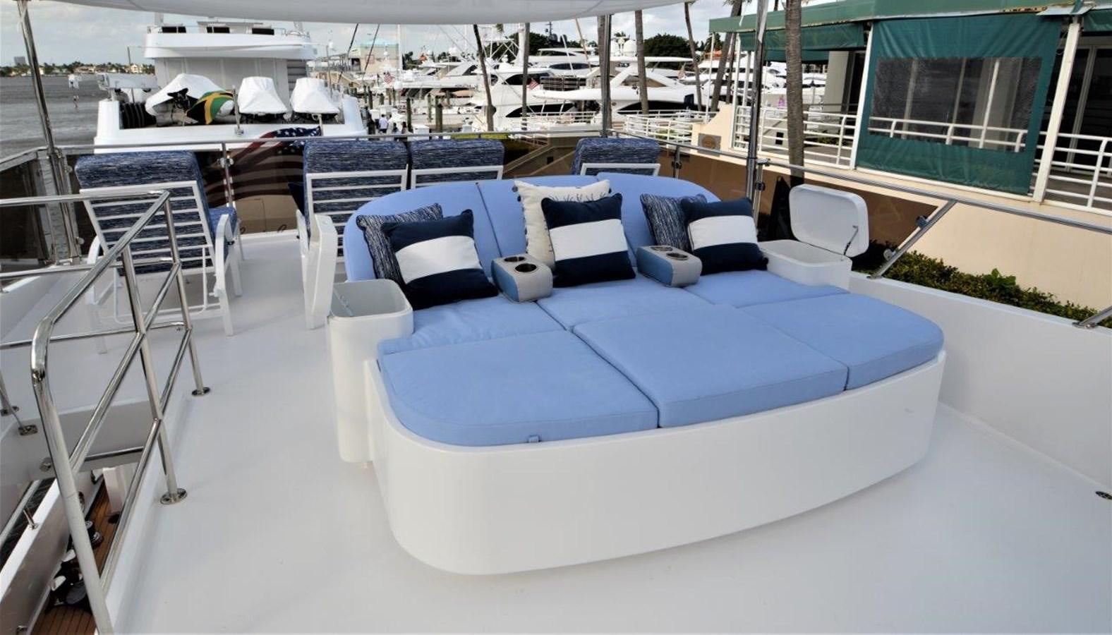 a large blue bed with white pillows aboard TRIPLE NET Yacht for Sale