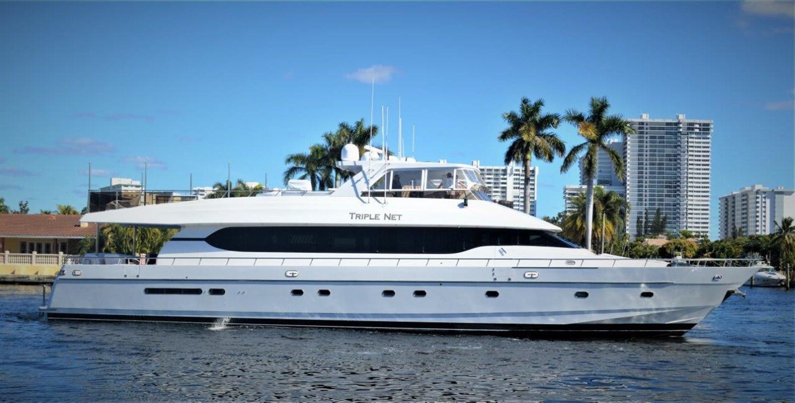 a white yacht on the water aboard TRIPLE NET Yacht for Sale