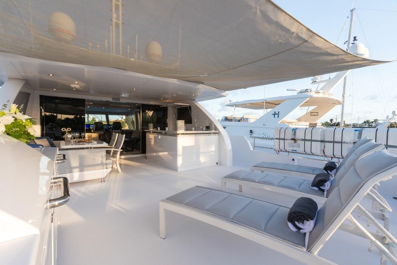 a room with a row of white tables and chairs aboard G-G Yacht for Sale
