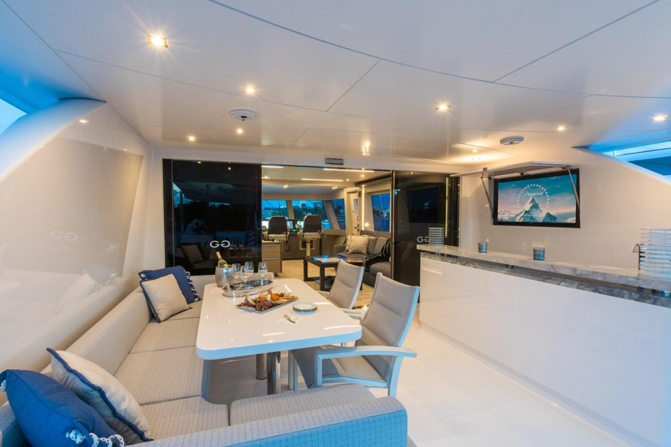 a room with a table and chairs aboard G-G Yacht for Sale