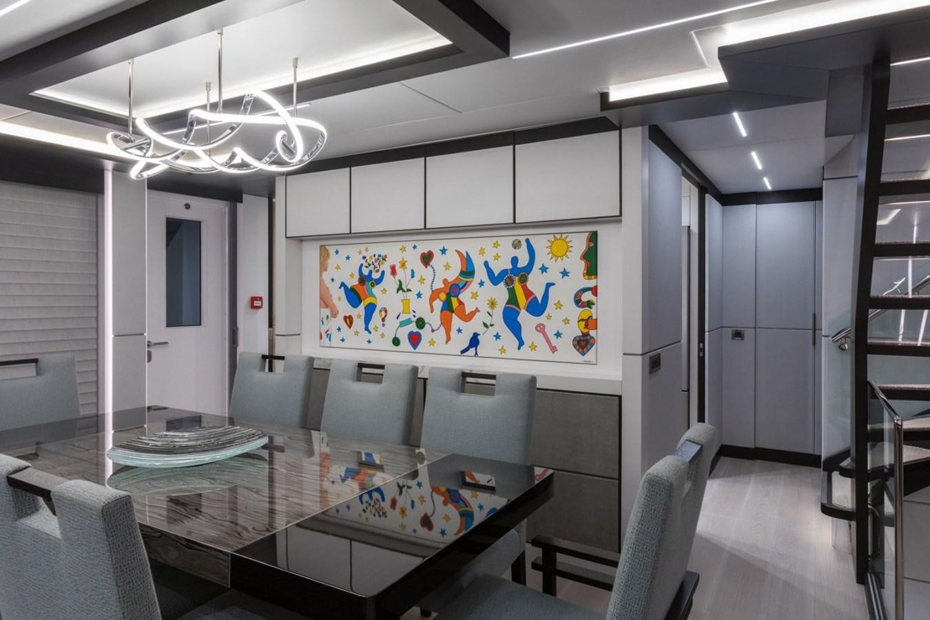 a room with a table and chairs aboard G-G Yacht for Sale