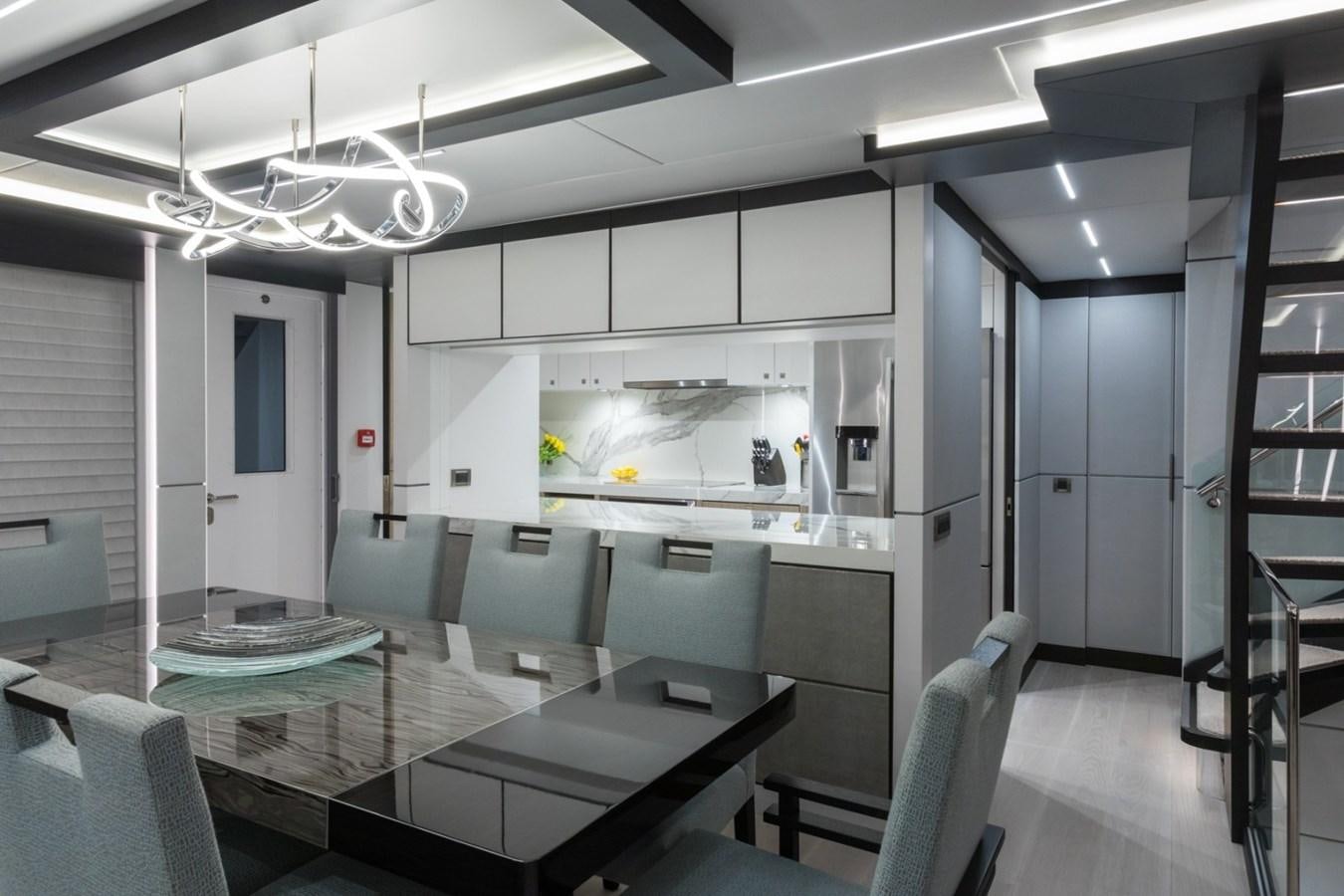 a room with a table and chairs aboard G-G Yacht for Sale