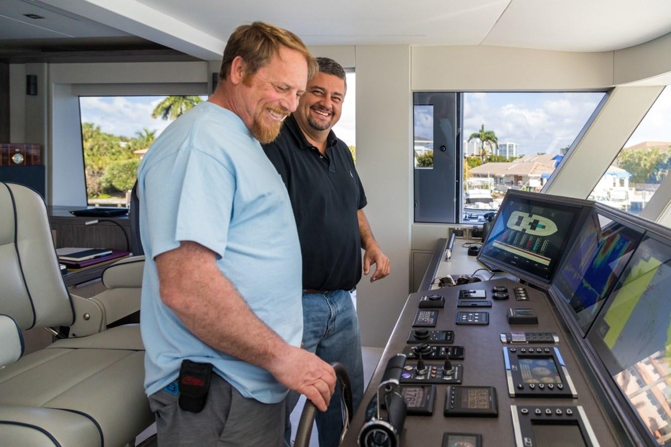 men standing in front of computers aboard G-G Yacht for Sale