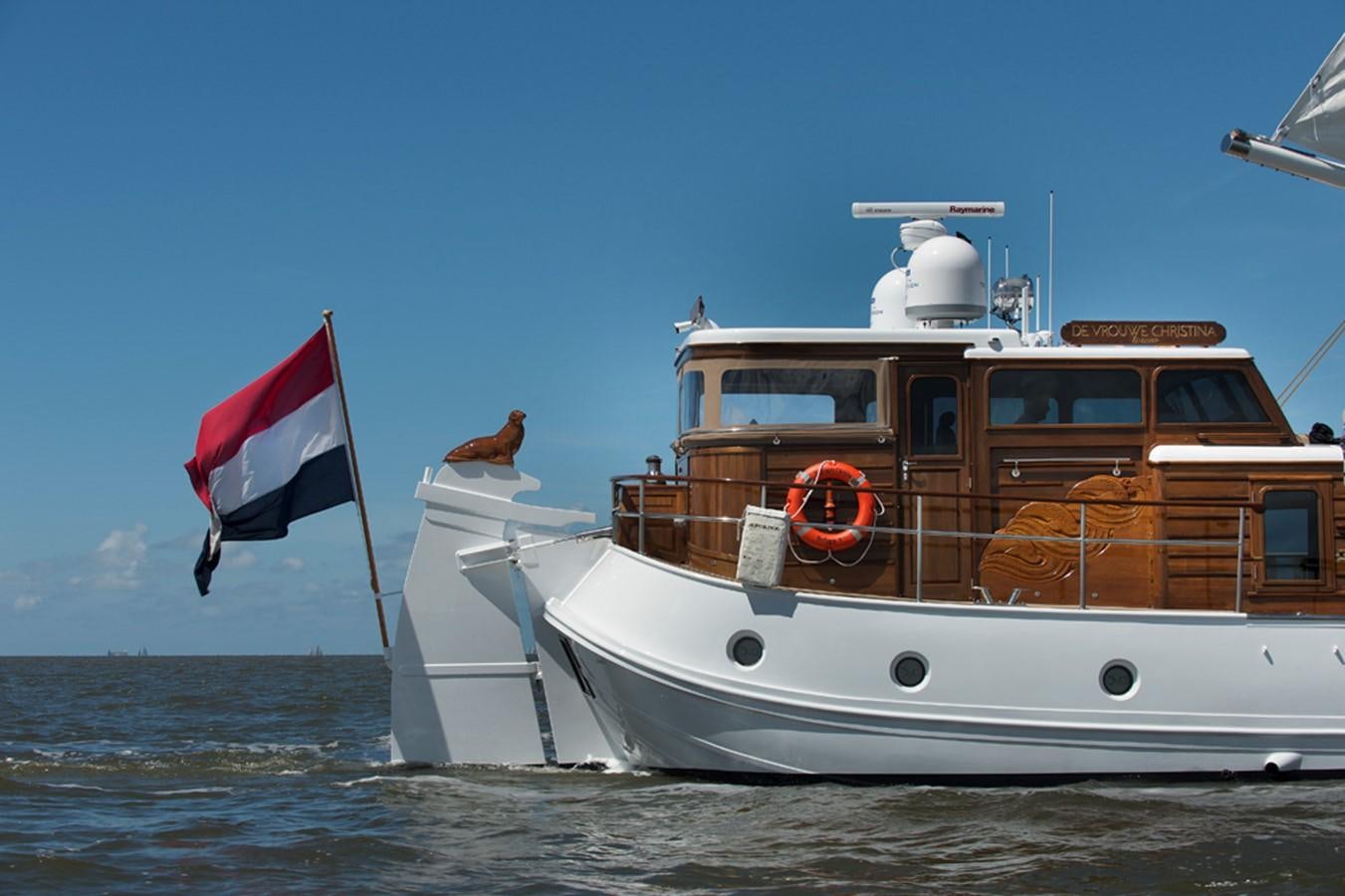 a boat with a flag on the front aboard DE VROUWE CHRISTINA Yacht for Sale