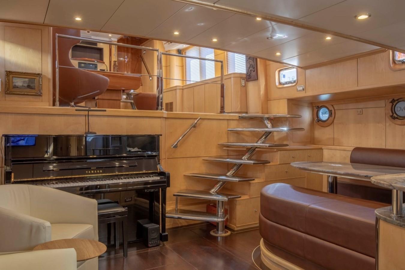 a room with a piano and a couch aboard DE VROUWE CHRISTINA Yacht for Sale