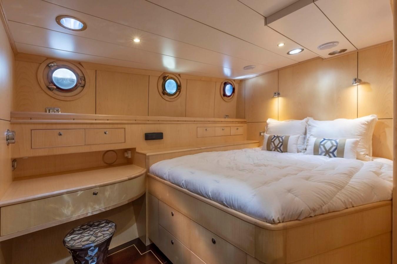 a room with beds and a mirror aboard DE VROUWE CHRISTINA Yacht for Sale