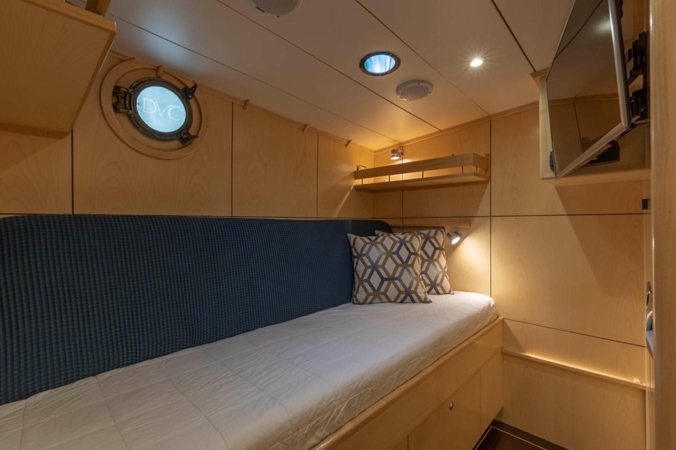 a bed with a blue sheet aboard DE VROUWE CHRISTINA Yacht for Sale