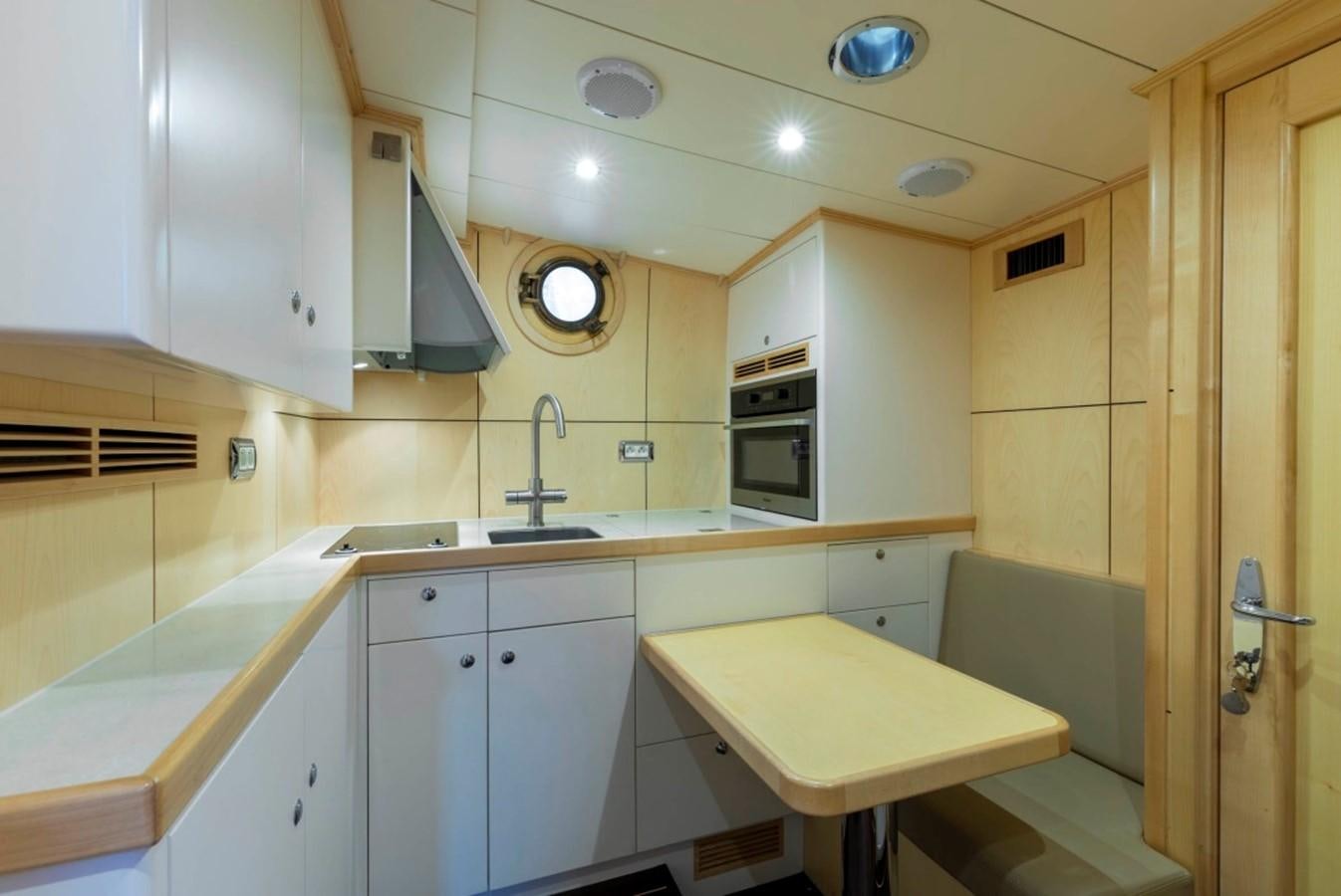 a kitchen with a table and a sink aboard DE VROUWE CHRISTINA Yacht for Sale