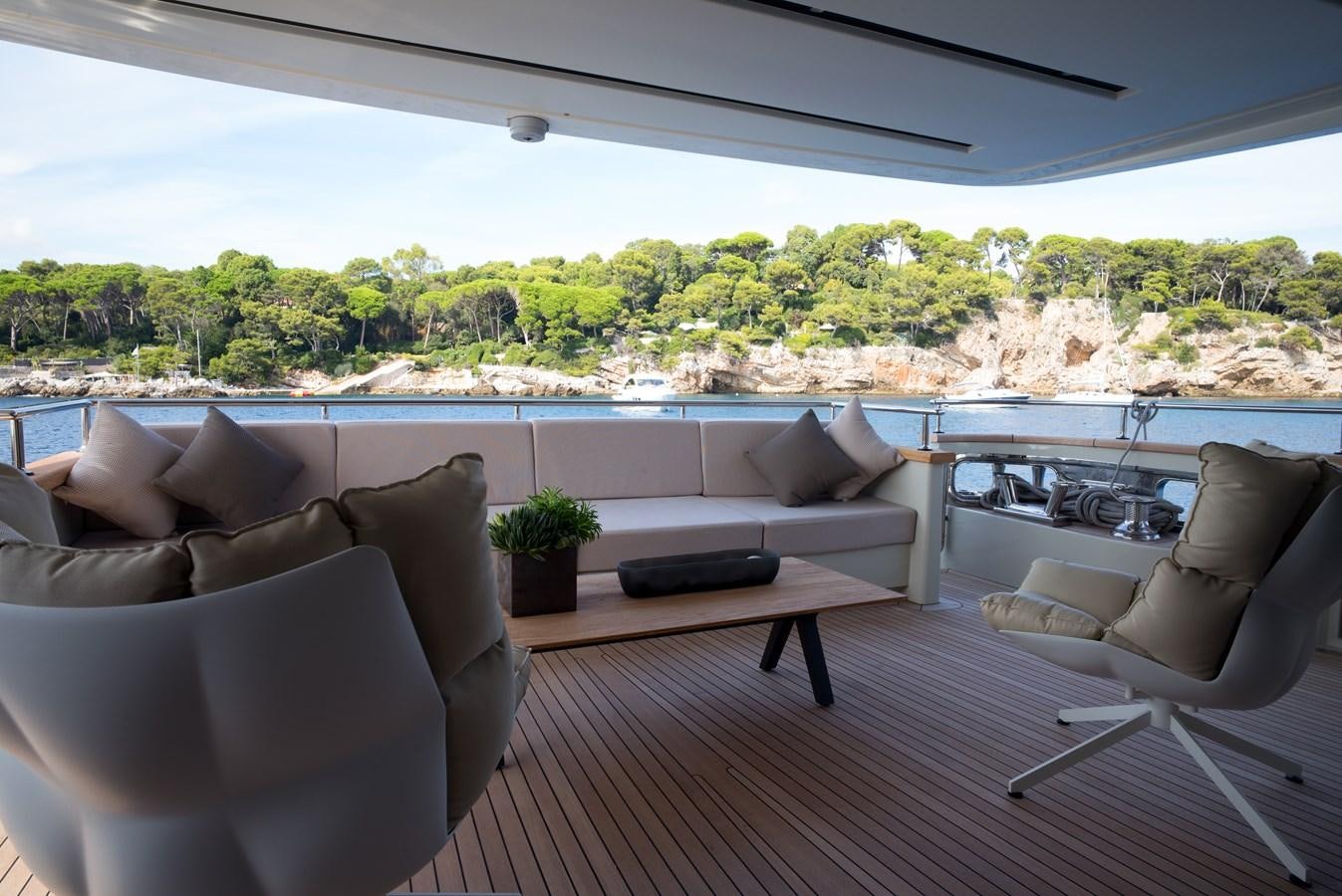 a room with couches and a table and a view of a city aboard ELMO Yacht for Sale