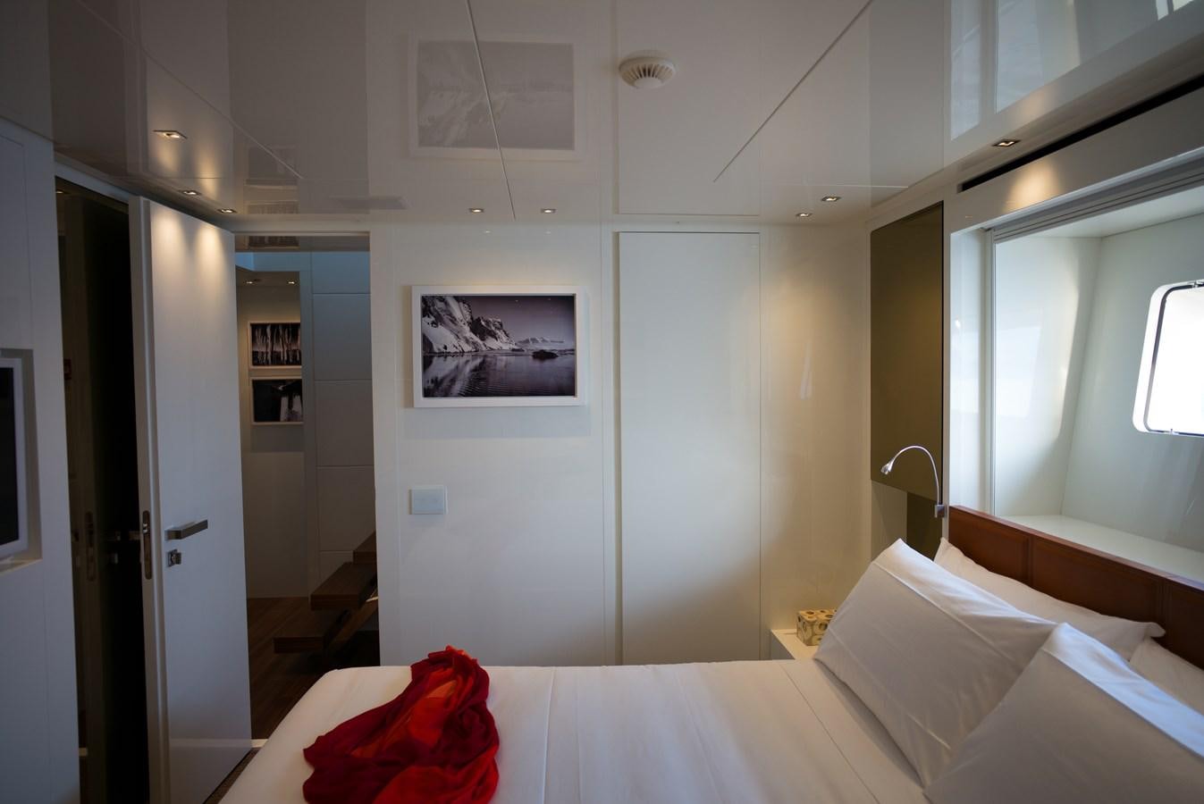 a room with a bed and a window aboard ELMO Yacht for Sale