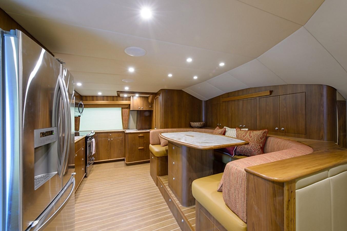 a room with a bed and a table aboard BANGARANG Yacht for Sale
