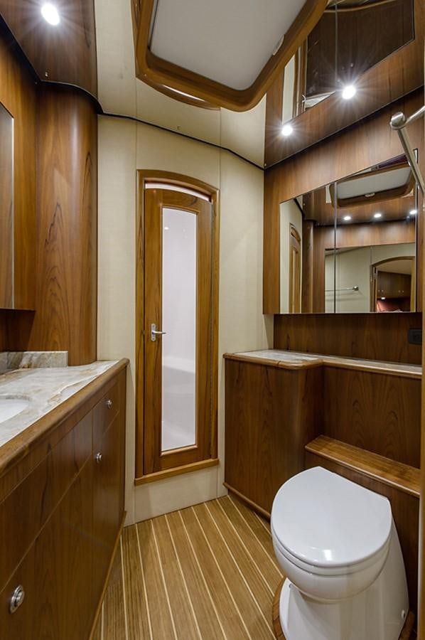 a bathroom with a toilet and a sink aboard BANGARANG Yacht for Sale