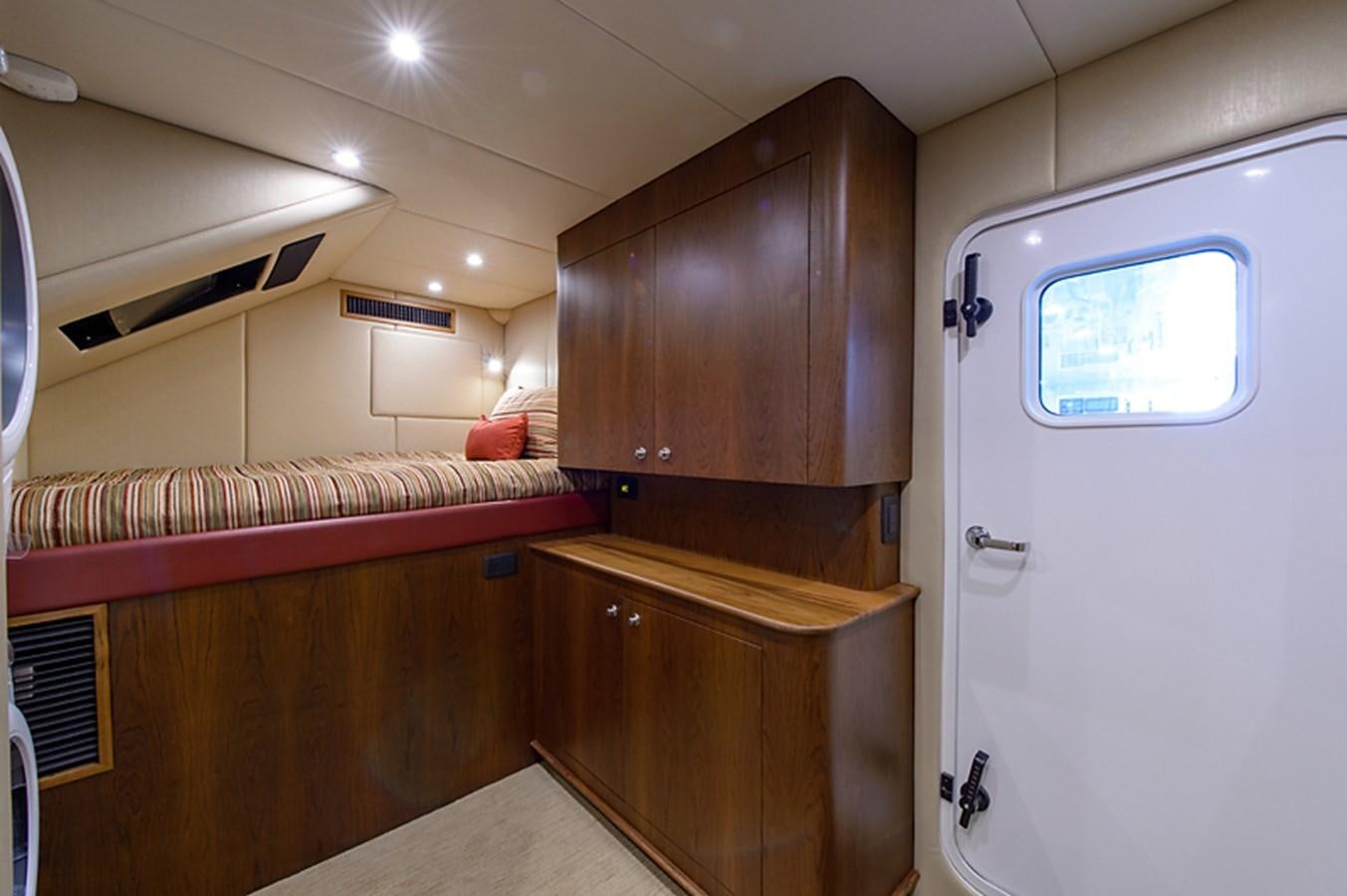 a room with a bed and a desk aboard BANGARANG Yacht for Sale