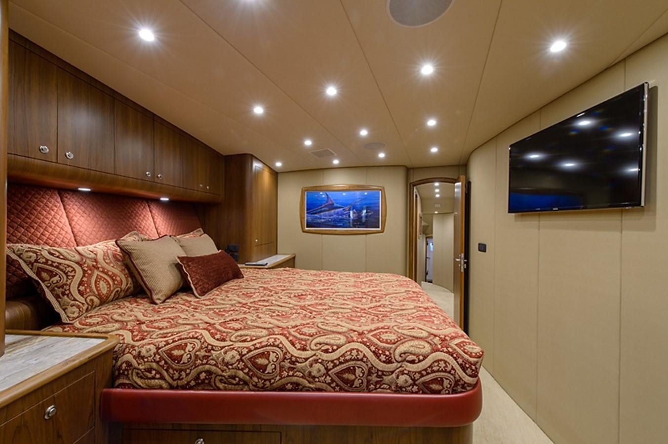a bed with a red comforter aboard BANGARANG Yacht for Sale