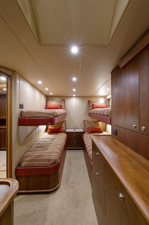 a bedroom with a bed and a desk aboard BANGARANG Yacht for Sale