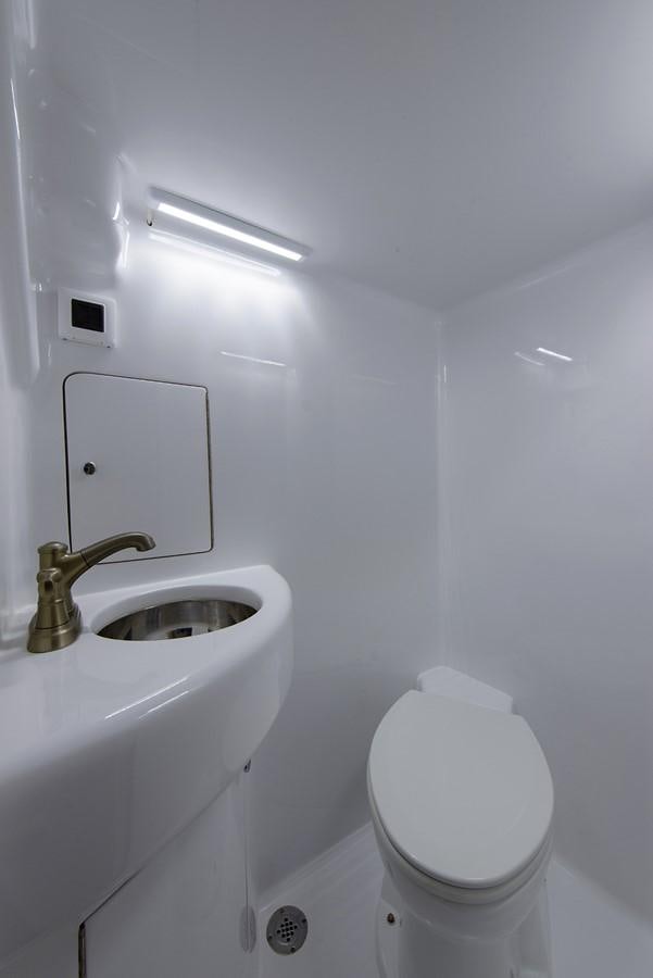 a small bathroom with a toilet aboard BANGARANG Yacht for Sale