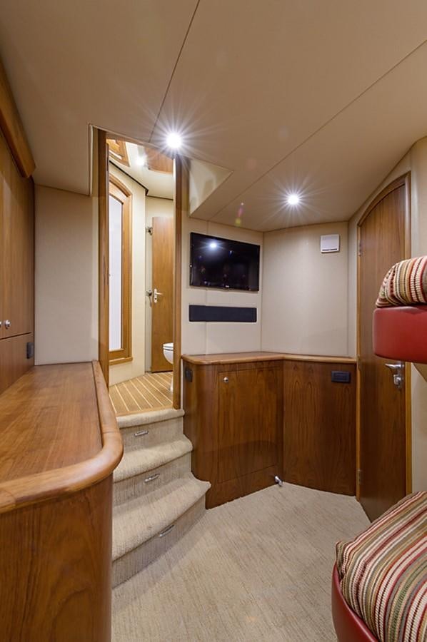 a room with a tv and a bed aboard BANGARANG Yacht for Sale