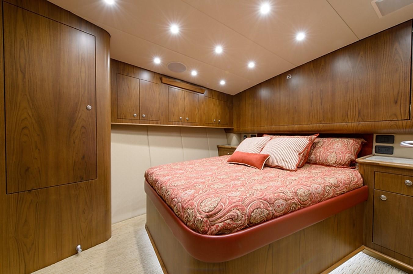 a bedroom with a bed and cabinets aboard BANGARANG Yacht for Sale