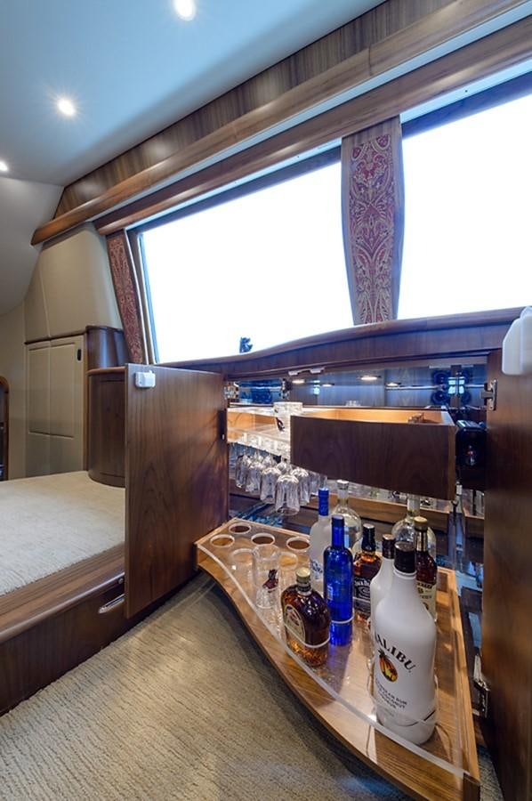 a wine rack with bottles and glasses aboard BANGARANG Yacht for Sale