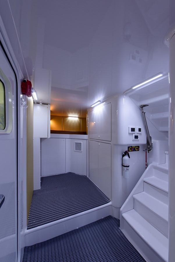 a hallway with a black and white striped rug aboard BANGARANG Yacht for Sale