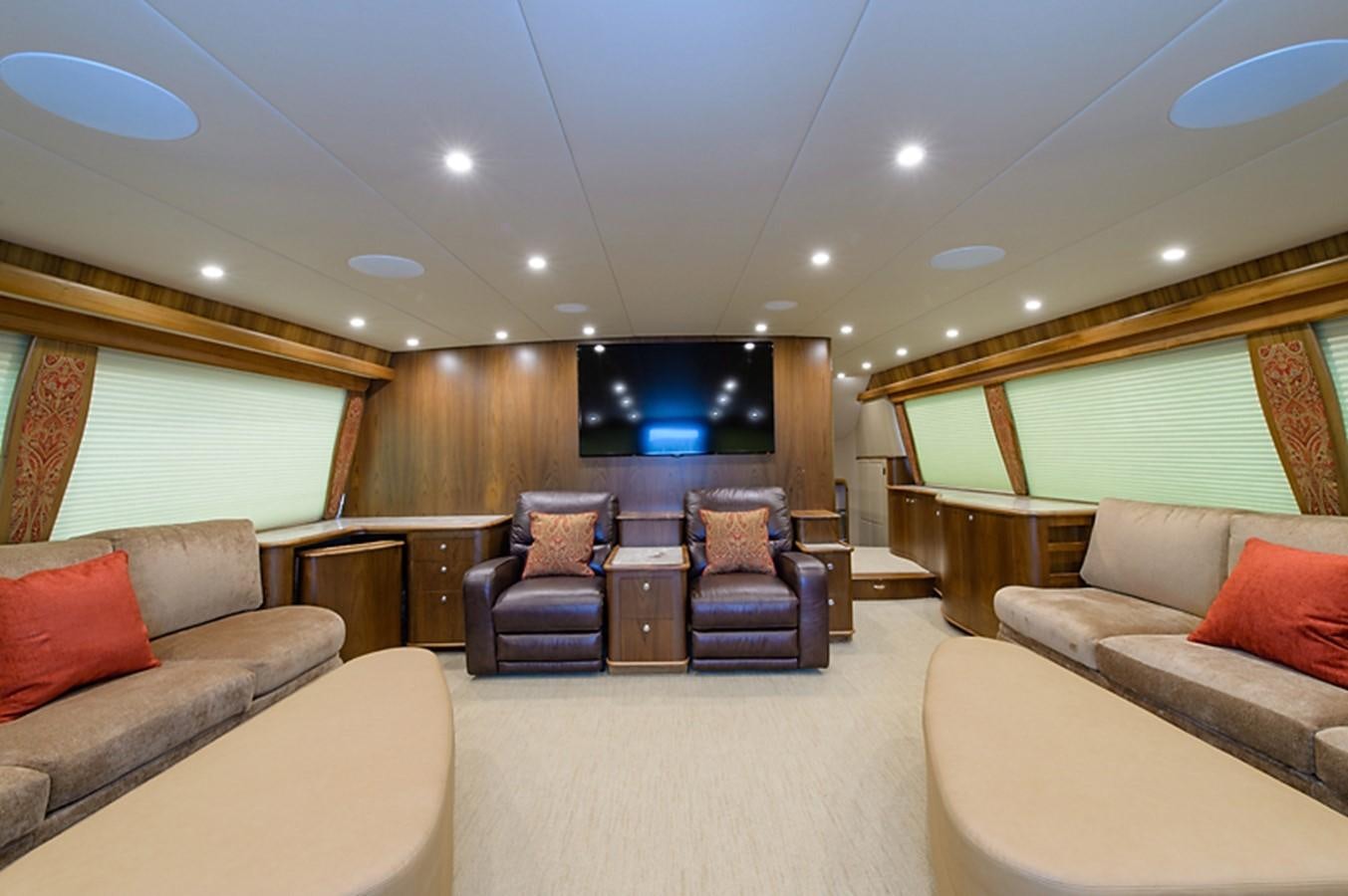 a living room with a couch and a tv aboard BANGARANG Yacht for Sale
