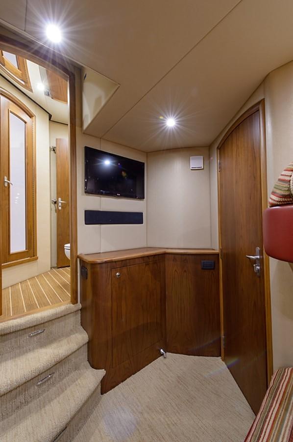 a room with a tv and a bed aboard BANGARANG Yacht for Sale