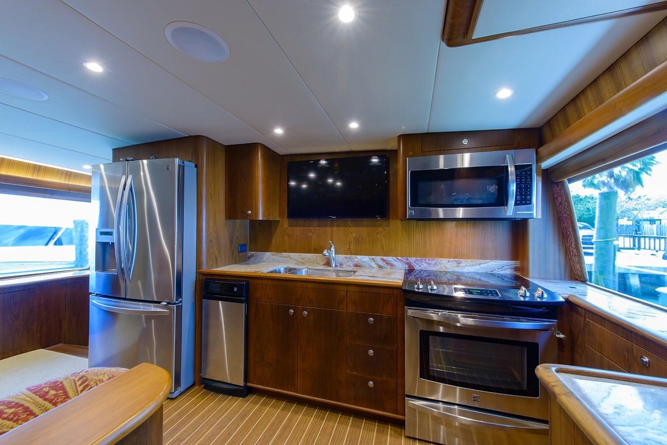 a kitchen with wooden cabinets aboard BANGARANG Yacht for Sale