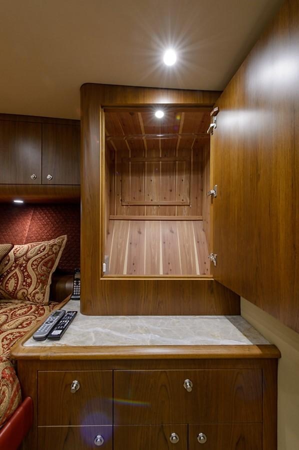 a wooden cabinet with a phone on it aboard BANGARANG Yacht for Sale