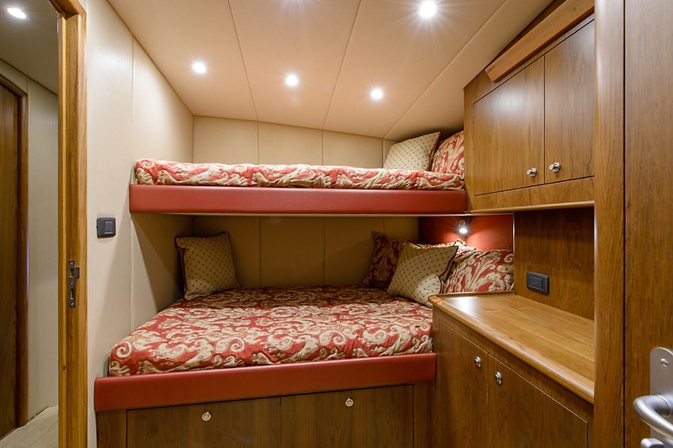 a bed with a red comforter aboard BANGARANG Yacht for Sale