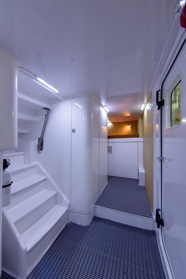 a long hallway with white walls aboard BANGARANG Yacht for Sale