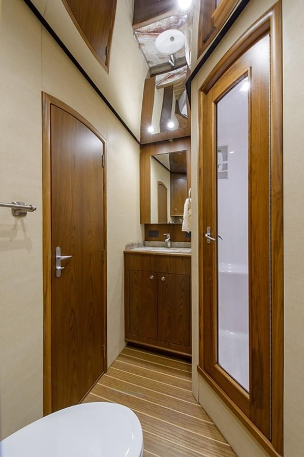 a bathroom with a toilet and a sink aboard BANGARANG Yacht for Sale