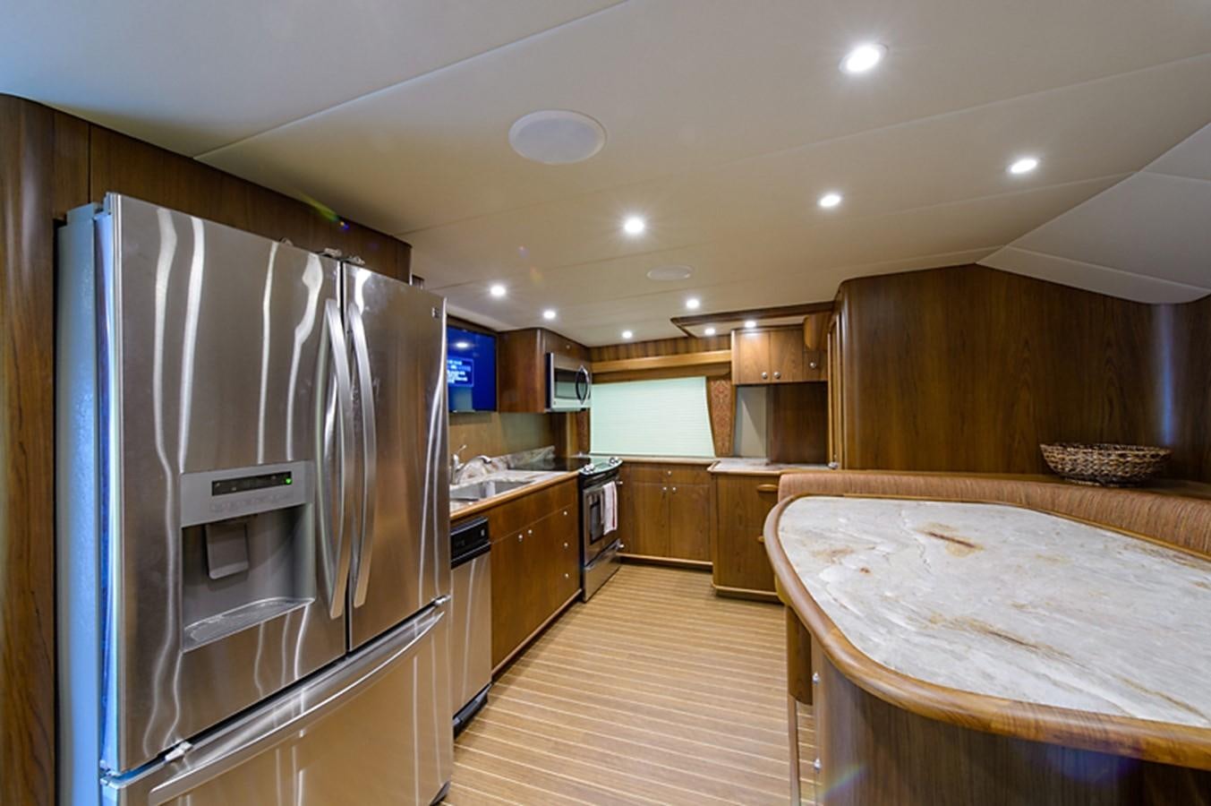 a kitchen with a large refrigerator aboard BANGARANG Yacht for Sale