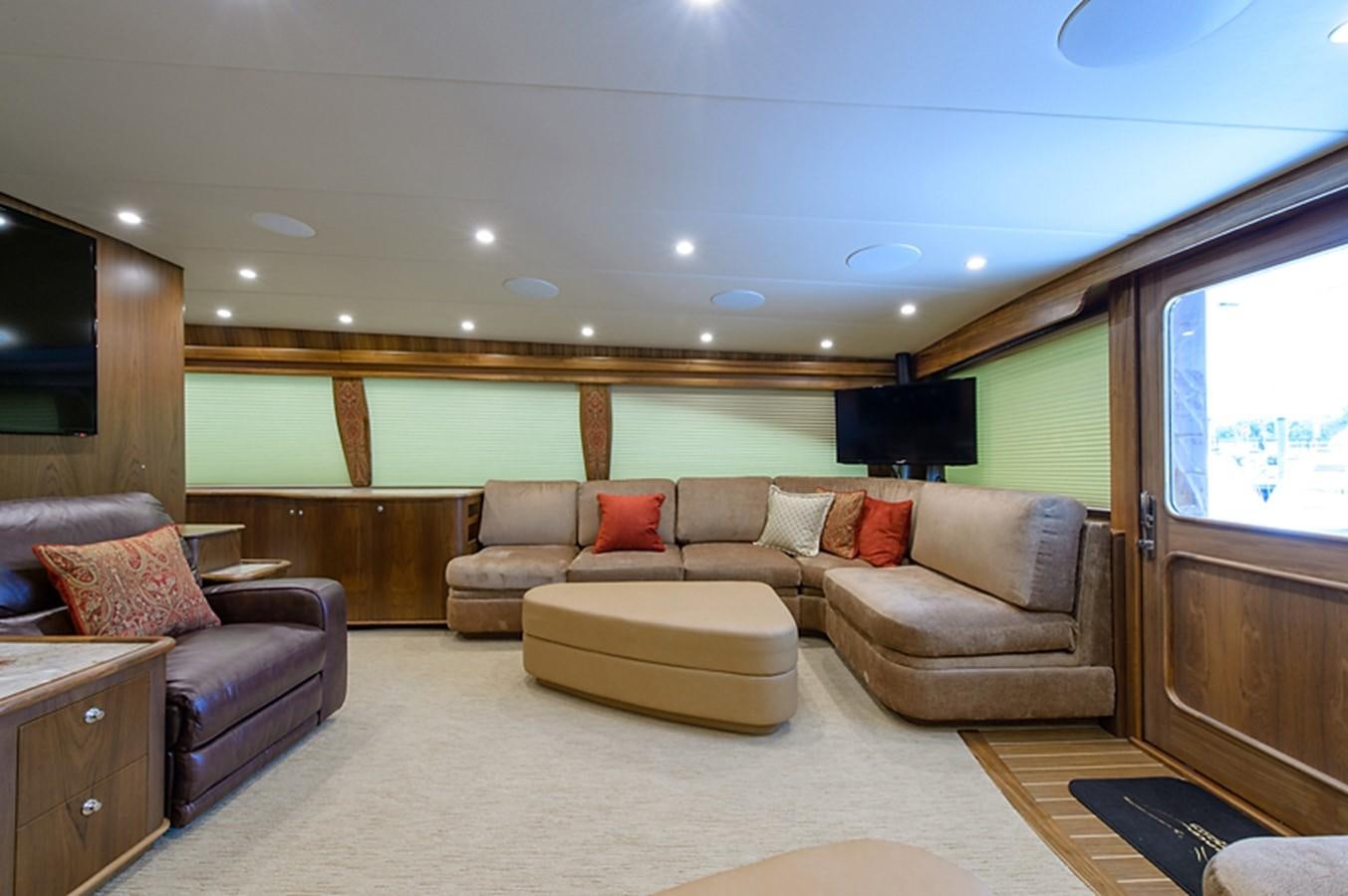 a living room with a couch and a tv aboard BANGARANG Yacht for Sale