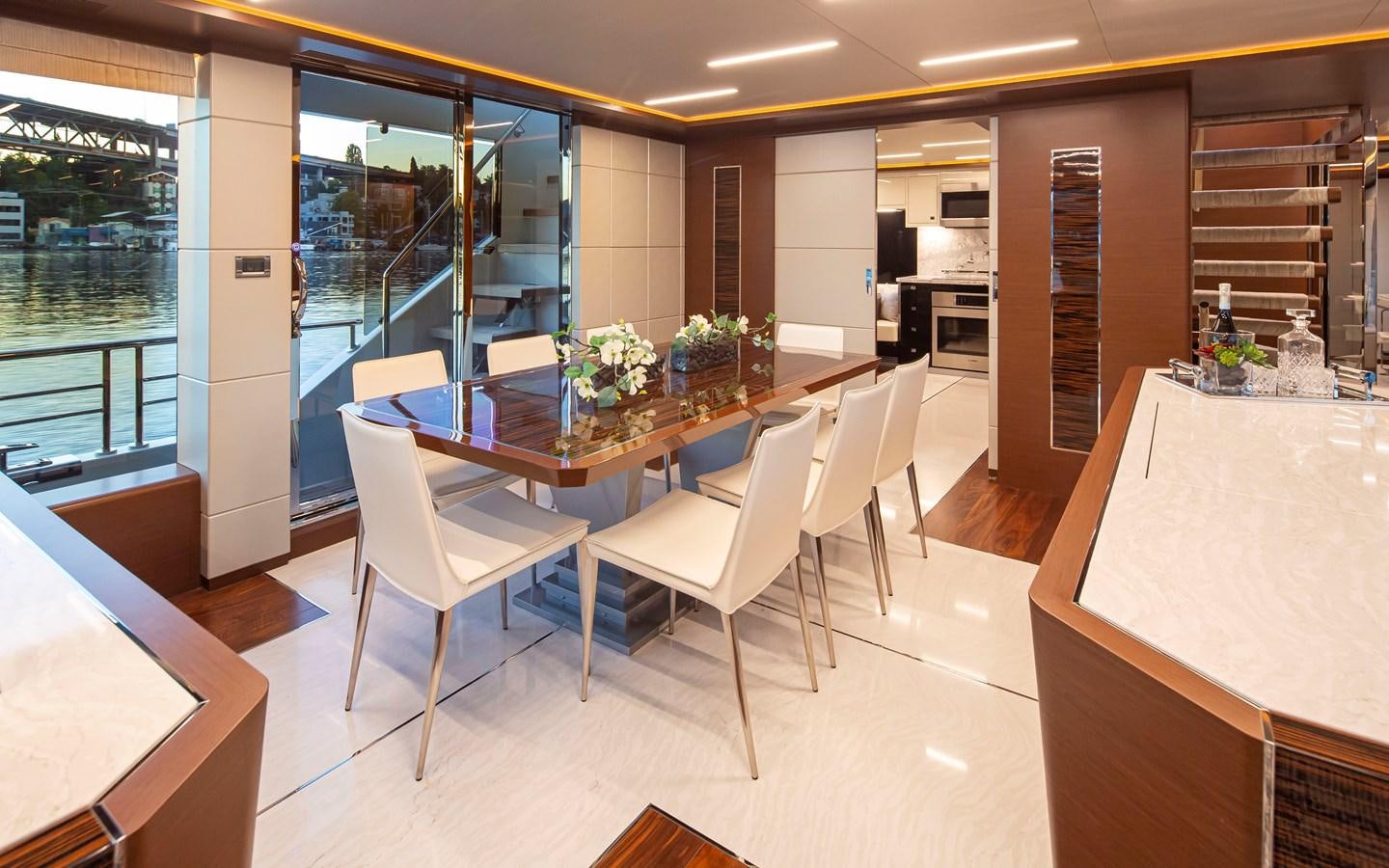 a room with tables and chairs aboard 90R03 Yacht for Sale