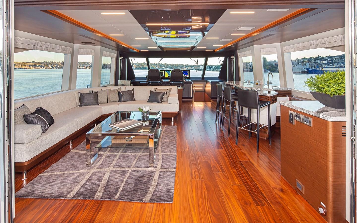 a living room with a couch and a table aboard 90R03 Yacht for Sale