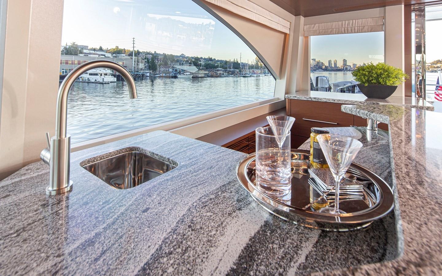a sink and a bowl on a counter by a window aboard 90R03 Yacht for Sale