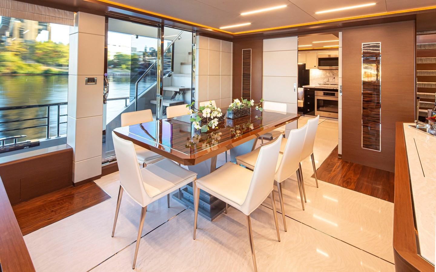 a room with a table and chairs aboard 90R03 Yacht for Sale