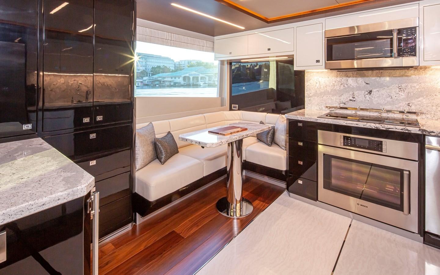 a kitchen with a couch and a table aboard 90R03 Yacht for Sale