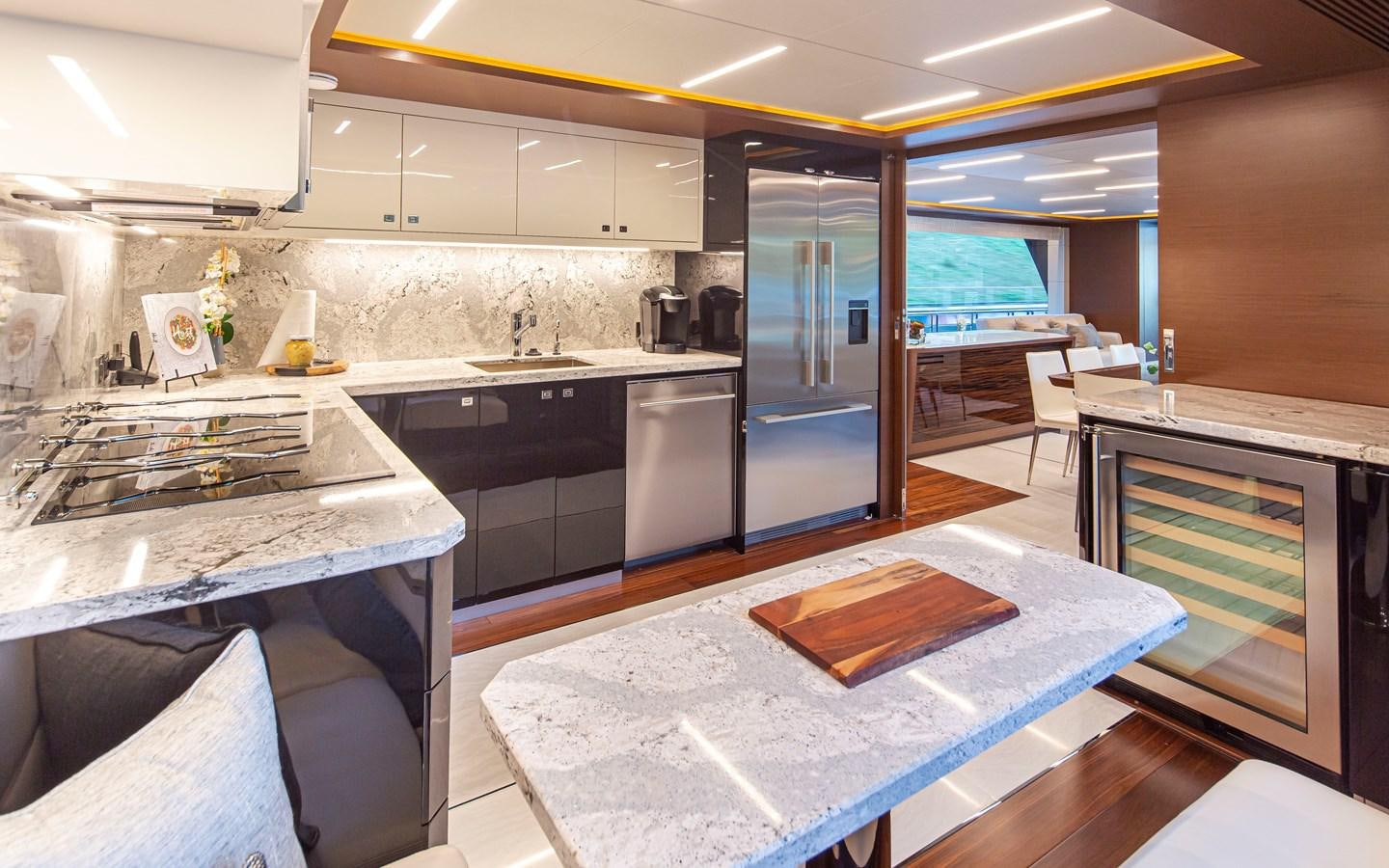 a kitchen with a large island aboard 90R03 Yacht for Sale